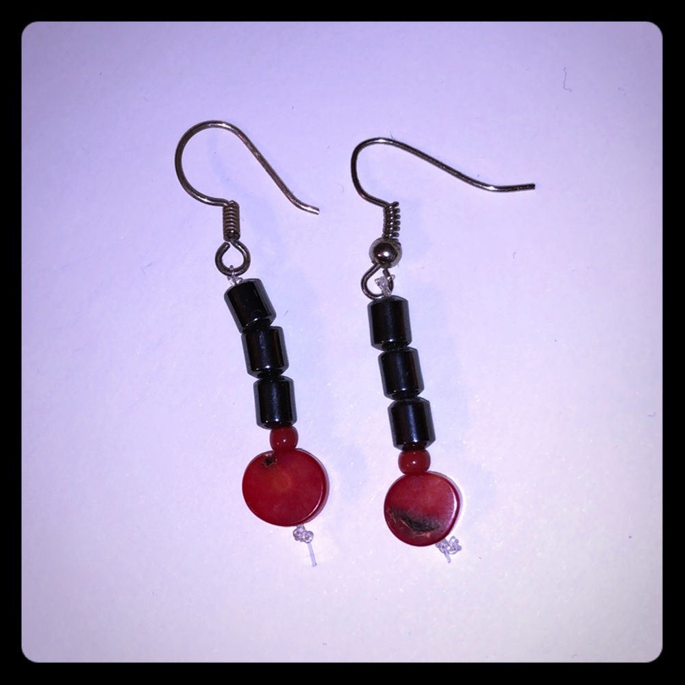 Beaded earrings with red and dark gray beads.